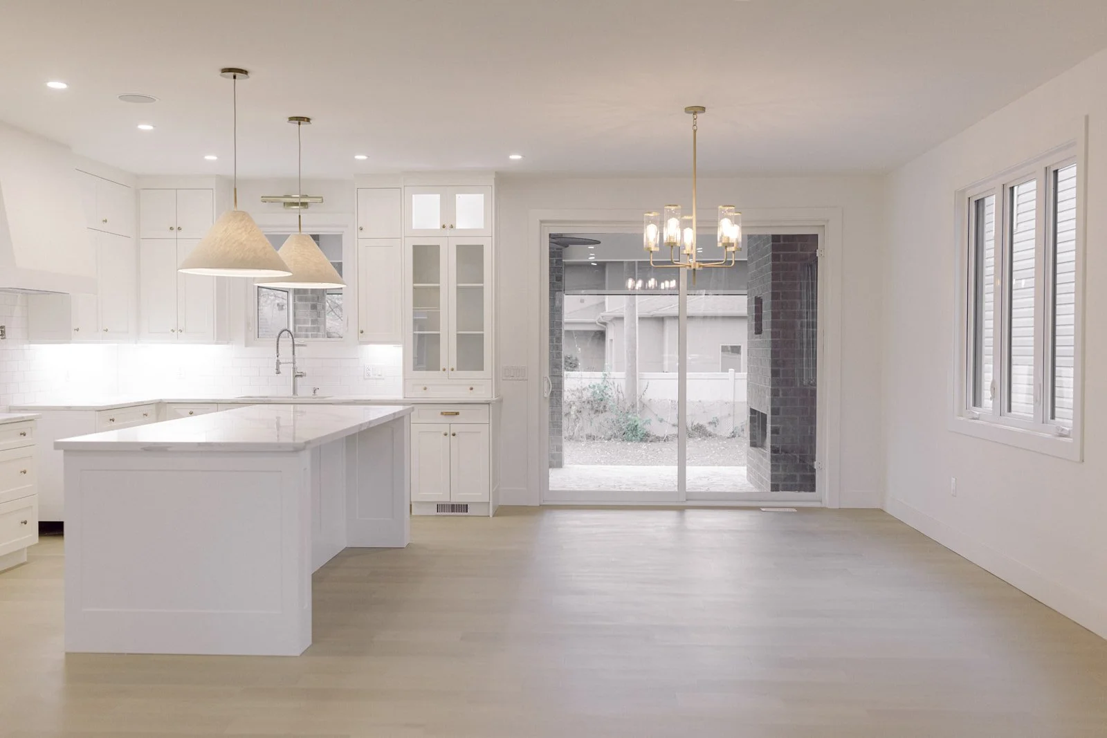 Bright, open white kitchen and living space in a Petvin home